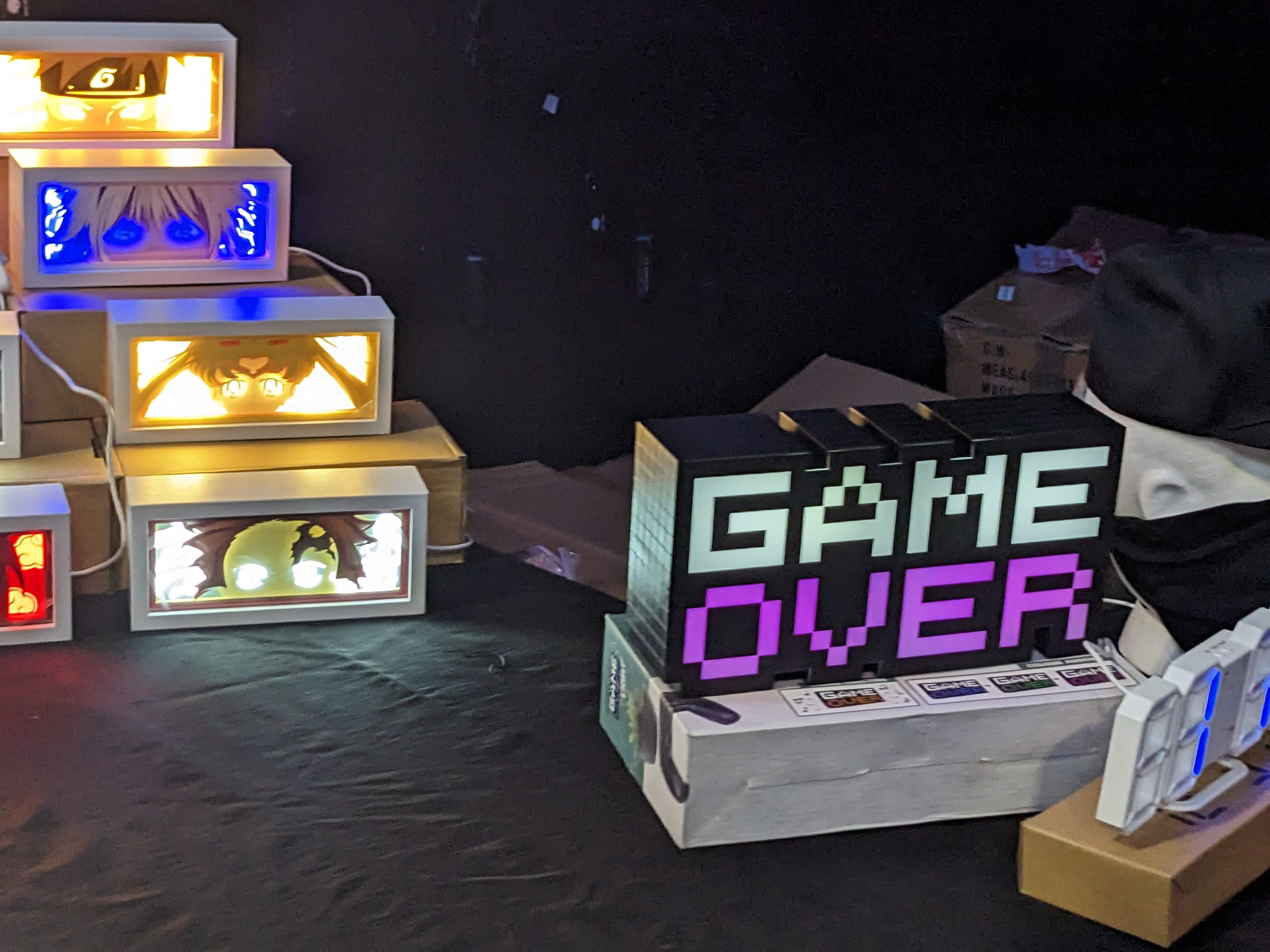 Glow box lights with popular anime characters and one with text reading 'game over'.
